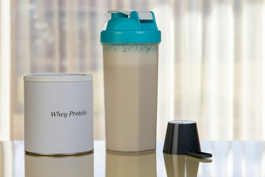 Whey protein jar with scoop and shaker bottle
